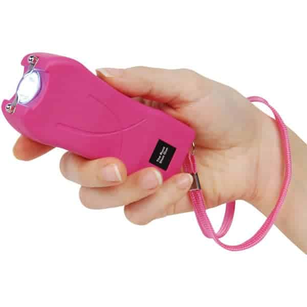 Pink Runt Rechargeable Stun Gun With Flashlight And Wrist Strap Disable Pin Shown in Hand