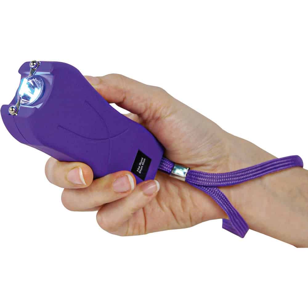 Purple Runt Rechargeable Stun Gun With Flashlight And Wrist Strap Disable Pin Shown in Hand