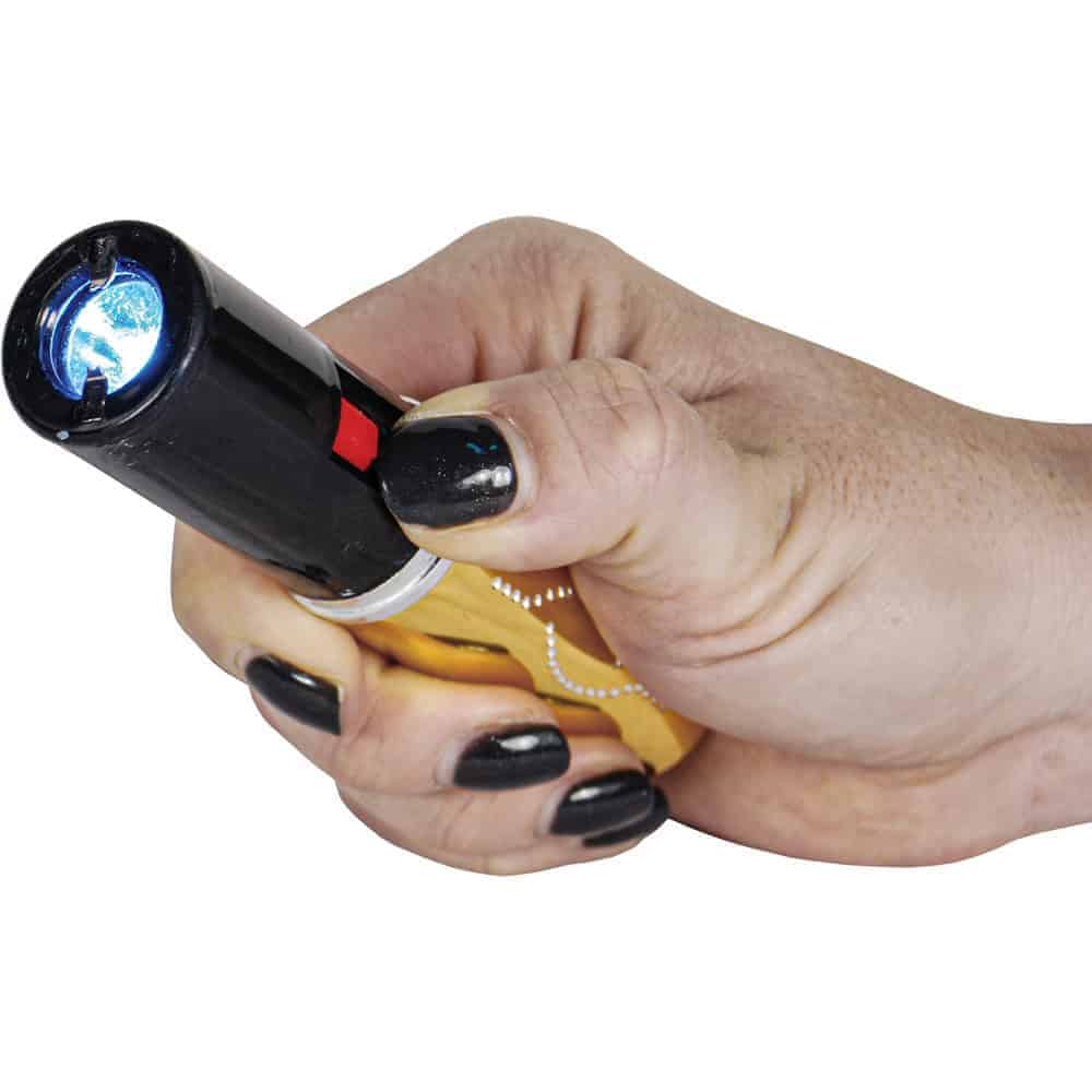 Gold 25 Million Volt Lipstick Stun Gun Rechargeable With Flashlight Shown in Hand