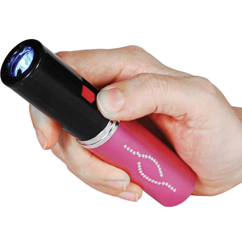 Pink 25 Million Volt Lipstick Stun Gun Rechargeable With Flashlight Shown in Hand