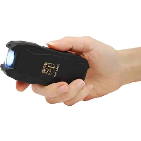 90 Million Volt Hot Shot Rechargeable Stun Gun with Flashlight and Battery Meter Shown in Hand
