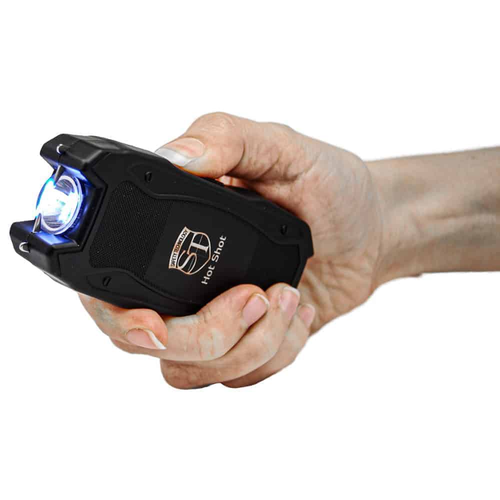 90 Million Volt Hot Shot Rechargeable Stun Gun with Flashlight and Battery Meter Shown in Hand