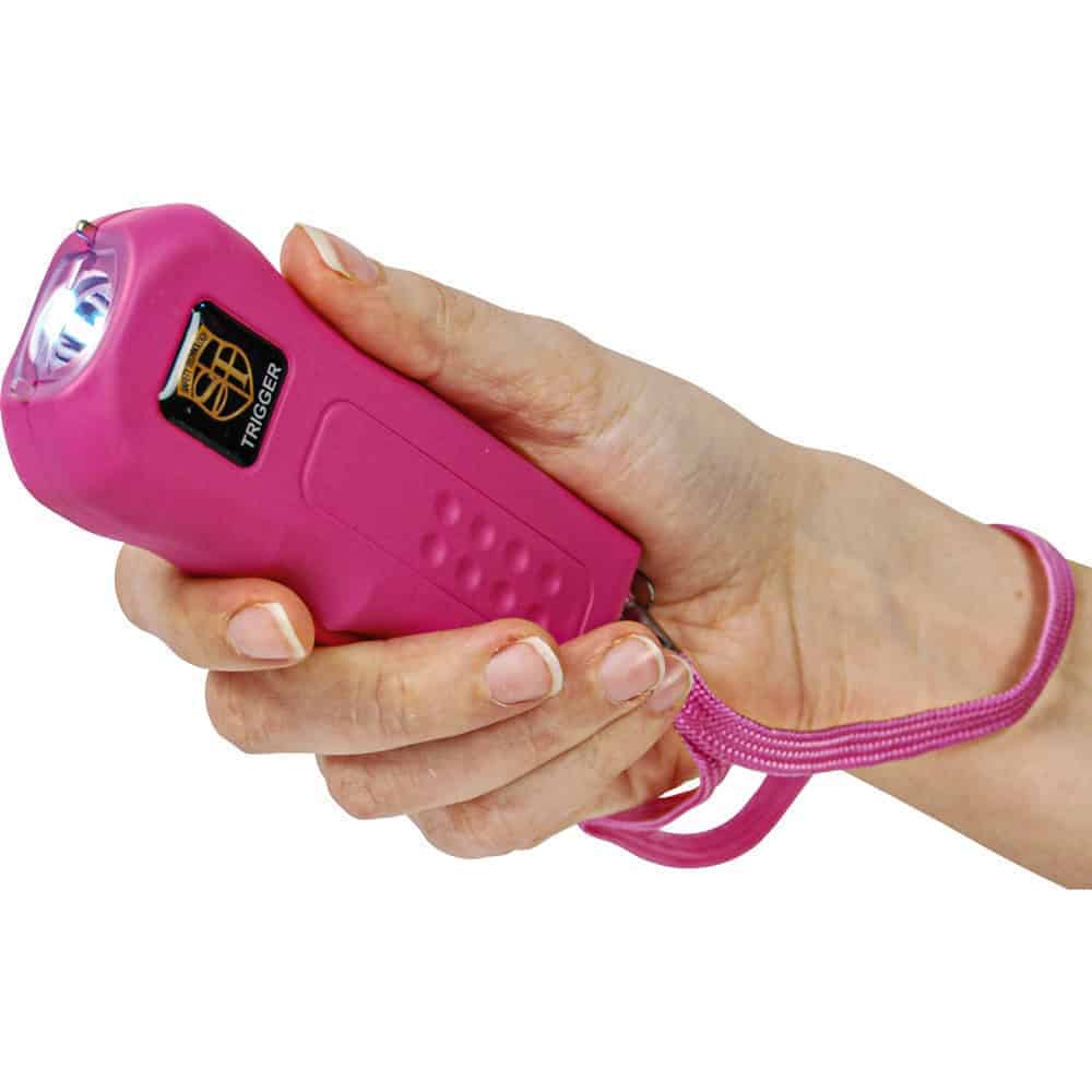 Pink 75 Million Volt Trigger Stun Gun Flashlight with Disable Pin Shown in Hand