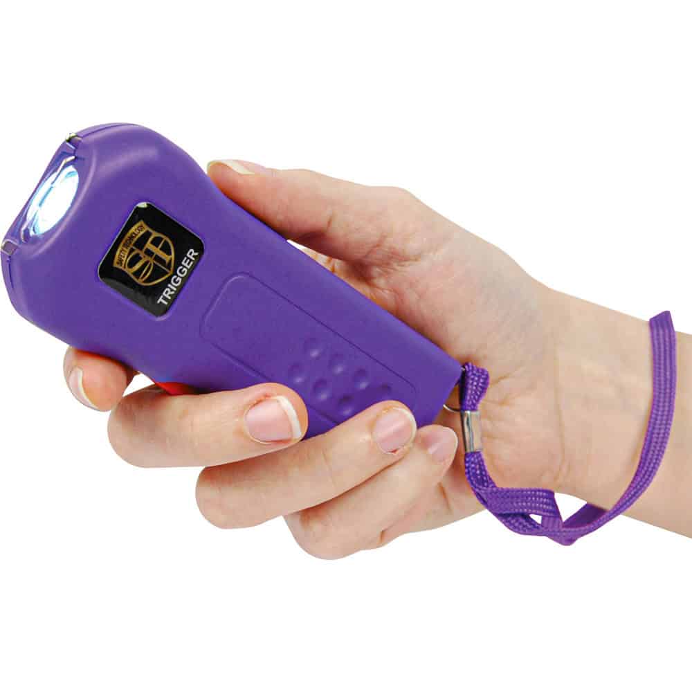 Purple 75 Million Volt Trigger Stun Gun Flashlight with Disable Pin Shown in Hand